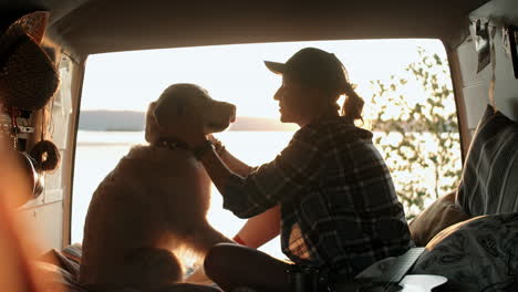 Woman-Petting-Dog-in-Van-at-Sunset-on-Lakeside